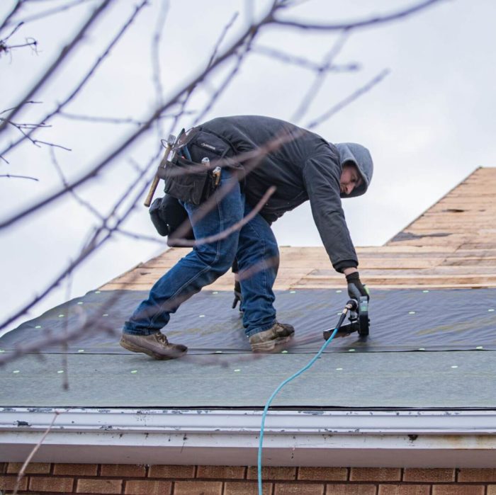 Canyon Construction Services employee installing a roof in Twin Falls, ID